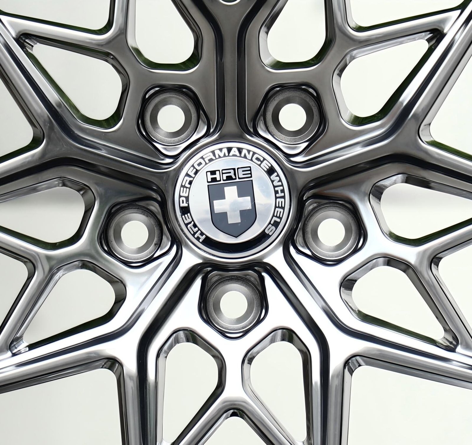 Close-up of an HRE forged wheel mounting face showing bolt holes and center bore