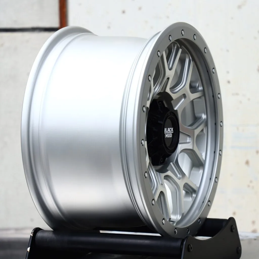 Toyota Tacoma wheels – Black Mud Silver Exposed Bolt Detail, angled view