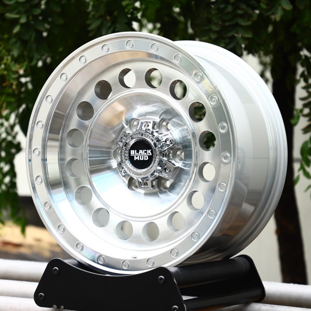 Toyota Tacoma wheels – Black Mud Silver Full-Face Exposed Bolt Detail Deep Lip, angled view