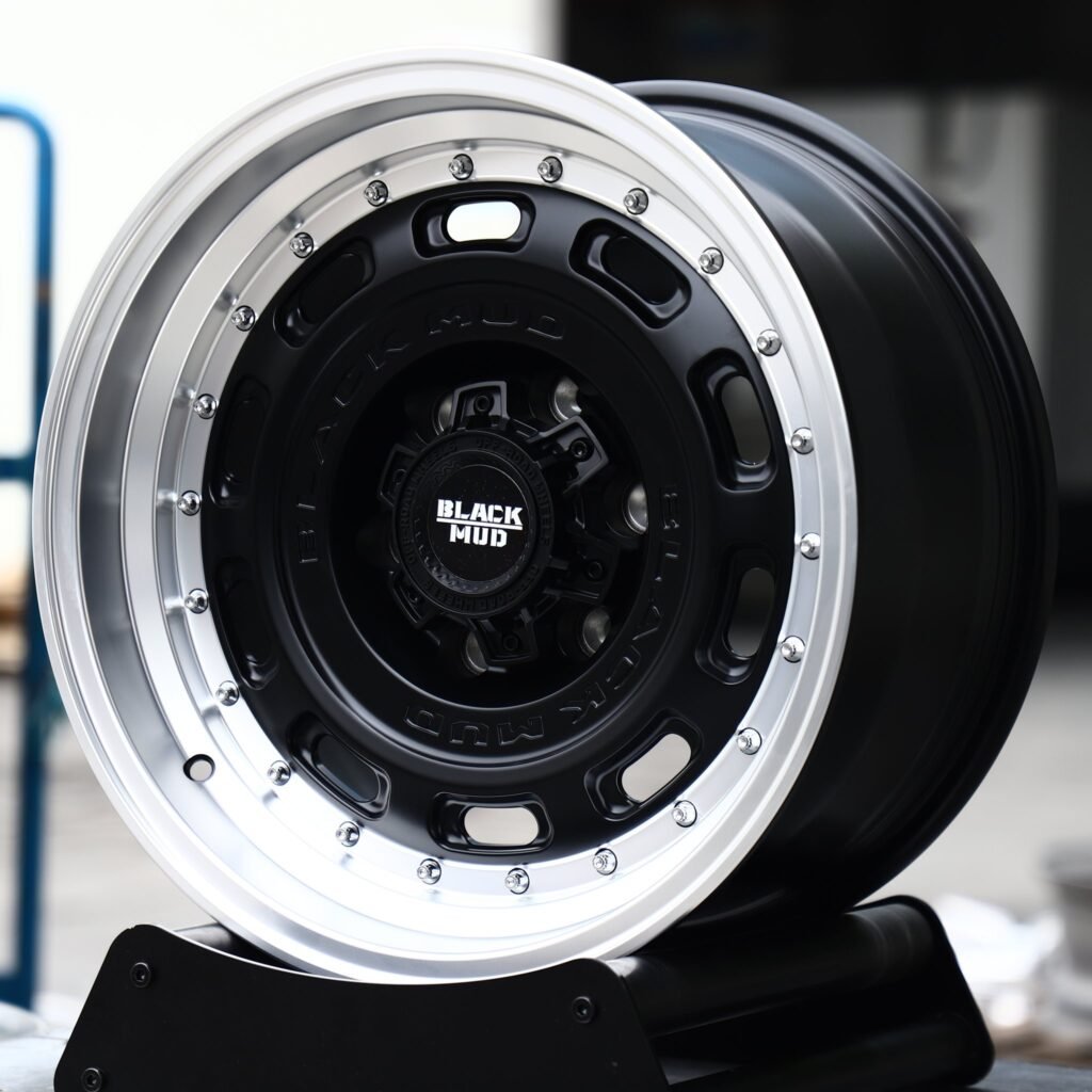 Toyota Tacoma wheels – Matte Black Slotted Dish Polished Riveted Lip (Black Mud-Style), angled view