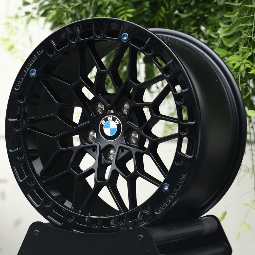 BMW M5 wheels – Matte Black Mesh Blue-Bolt Beadlock (BMW OEM-Style), angled view