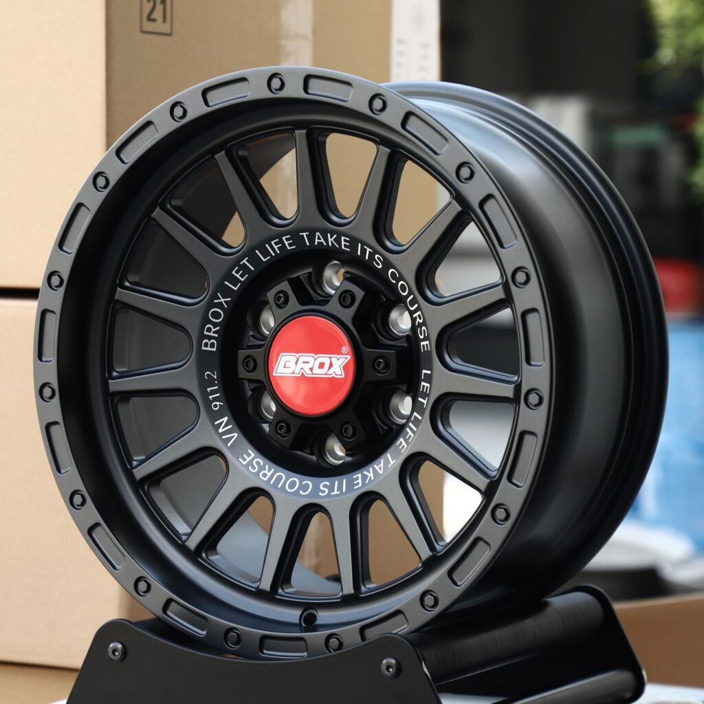 Toyota Tacoma wheels – BROX Gloss Black / Gunmetal / Gray 15-Spoke Exposed Bolt Detail, angled view