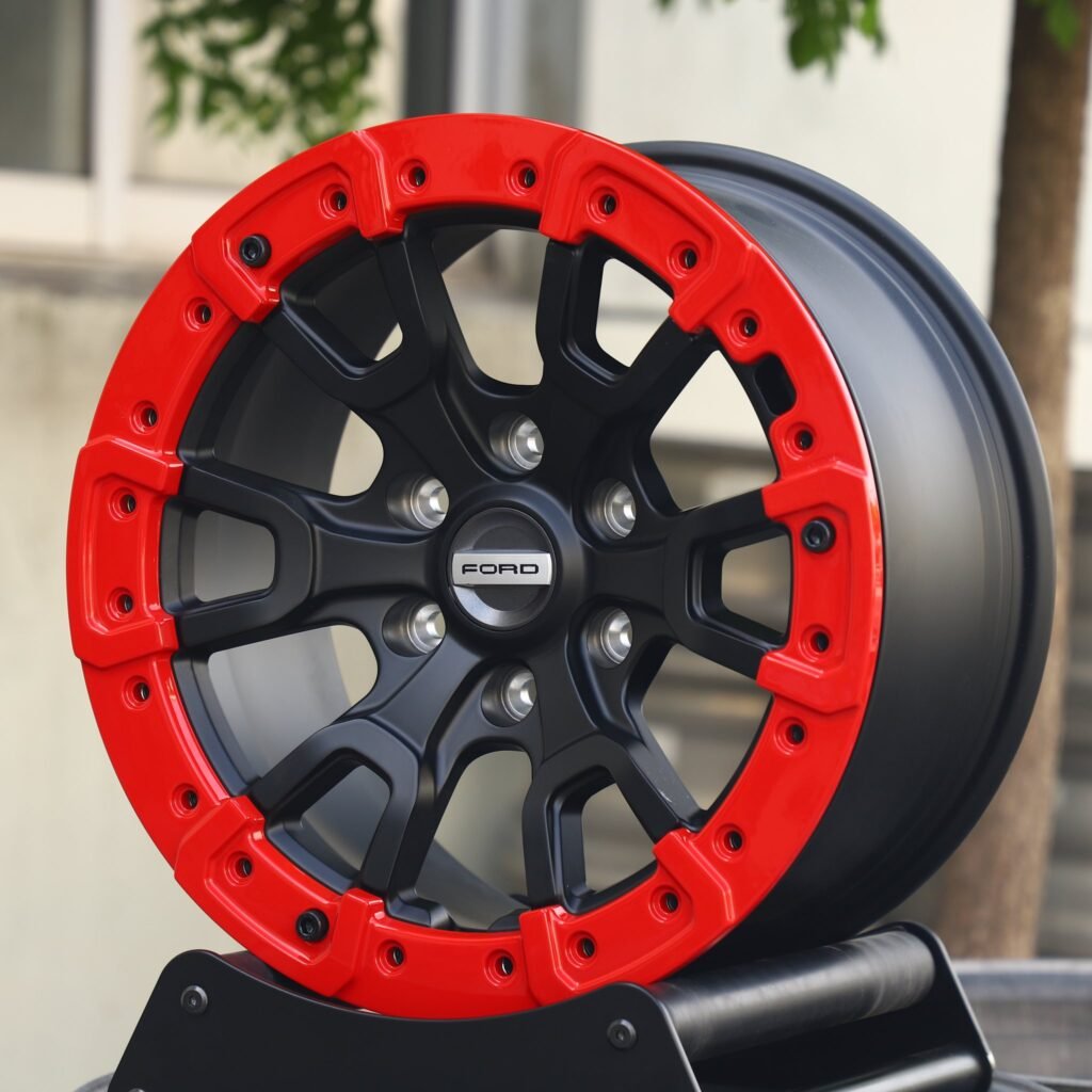 Ford Bronco wheels – Gloss Black / Red Beadlock (Ford OEM-Style), angled view