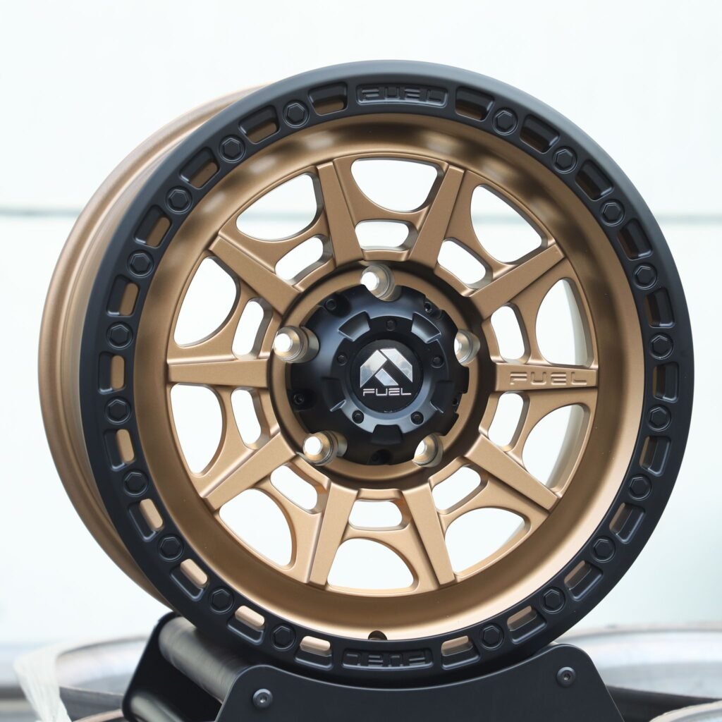 Toyota Tacoma wheels – Fuel Gloss Black / Bronze Exposed Bolt Detail Double Ring Lip, angled view