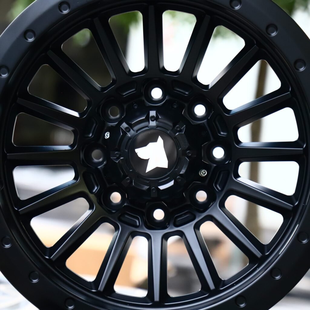 8x165.1 wheels – Gloss Black 16-Spoke Exposed Bolt Detail, side view