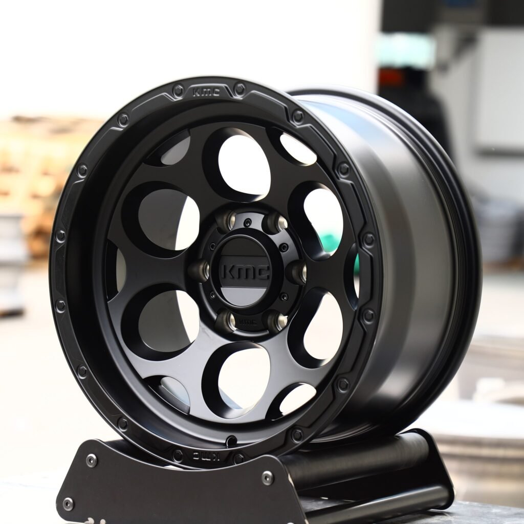 Toyota Tacoma wheels – Gloss Black Deep Lip Exposed Bolt Detail (KMC-Style), angled view