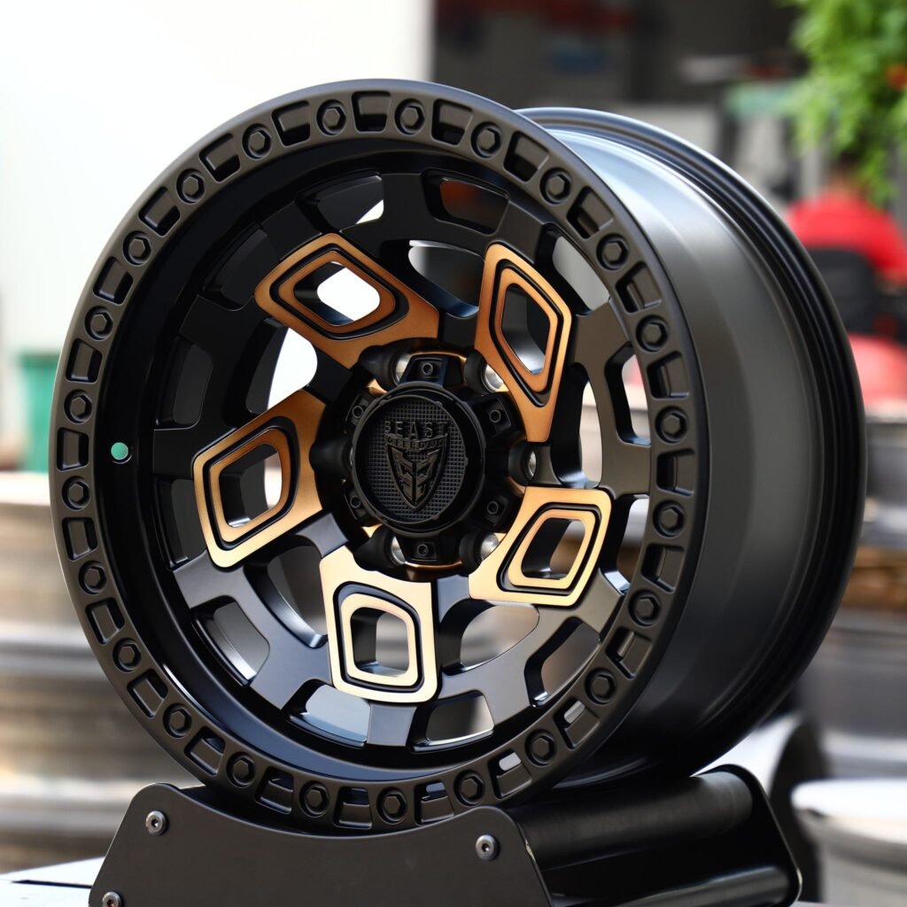 Toyota Tacoma wheels – Gloss Black / Gold Exposed Bolt Detail, angled view