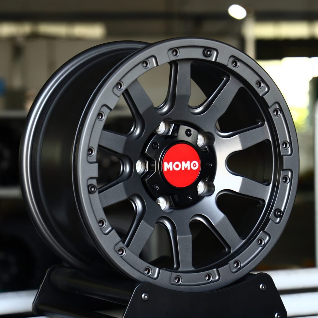 Toyota Tacoma wheels – Gray / Gloss Black / Gunmetal Custom Beadlock (Momo-Style), angled view