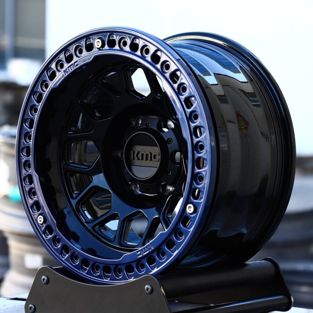 Toyota Tacoma wheels – KMC Blue / Gloss Black Beadlock, angled view