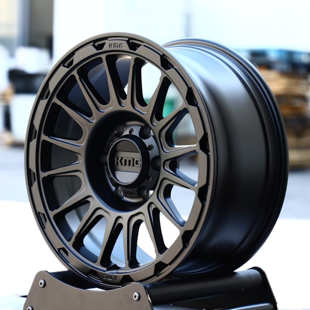 Toyota Tacoma wheels – KMC Gloss Black 16-Spoke, angled view