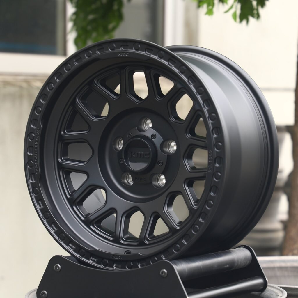 Toyota Tacoma wheels – KMC Gloss Black Exposed Bolt Detail, angled view