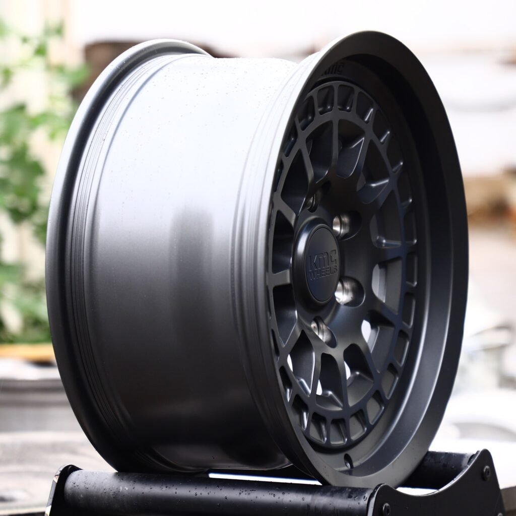 Toyota Tacoma wheels – KMC Gloss Black / Gunmetal Deep Lip, angled view