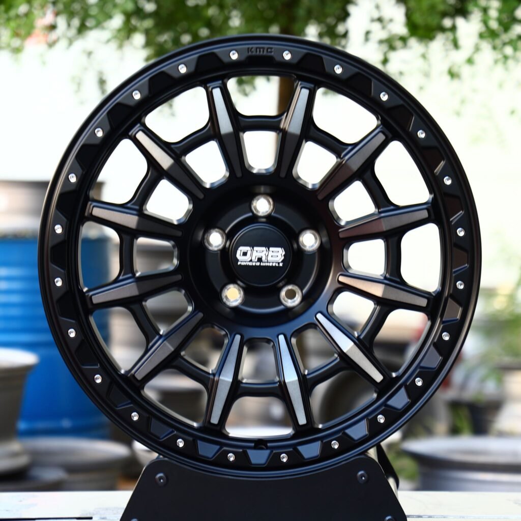 Toyota 4Runner wheels – KMC Gloss Black Machined Face Riveted Double Ring Lip, front view