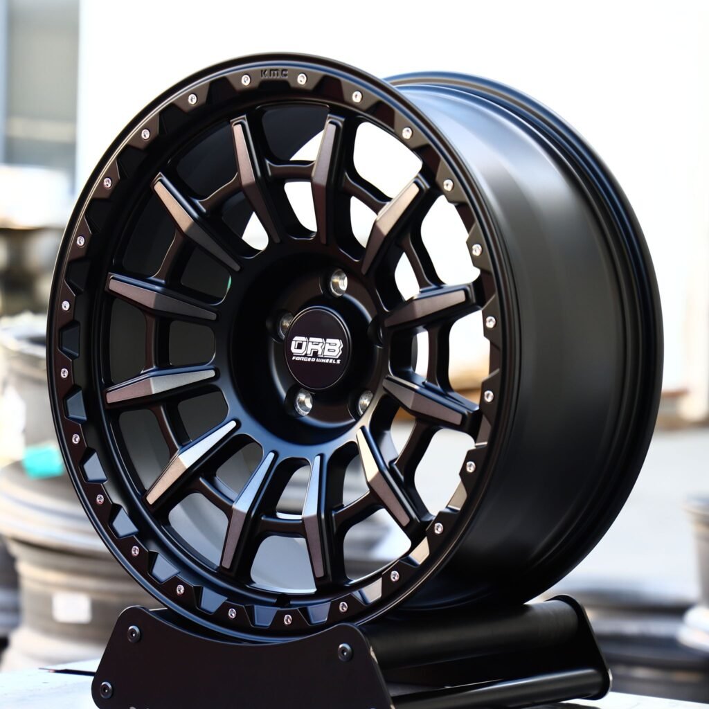 Toyota Tacoma wheels – KMC Gloss Black Machined Face Riveted Double Ring Lip, angled view
