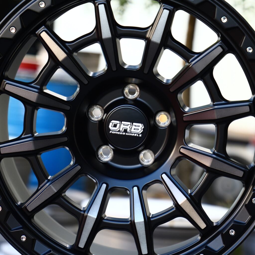 Chevrolet Silverado 1500 wheels – KMC Gloss Black Machined Face Riveted Double Ring Lip, lip and barrel detail