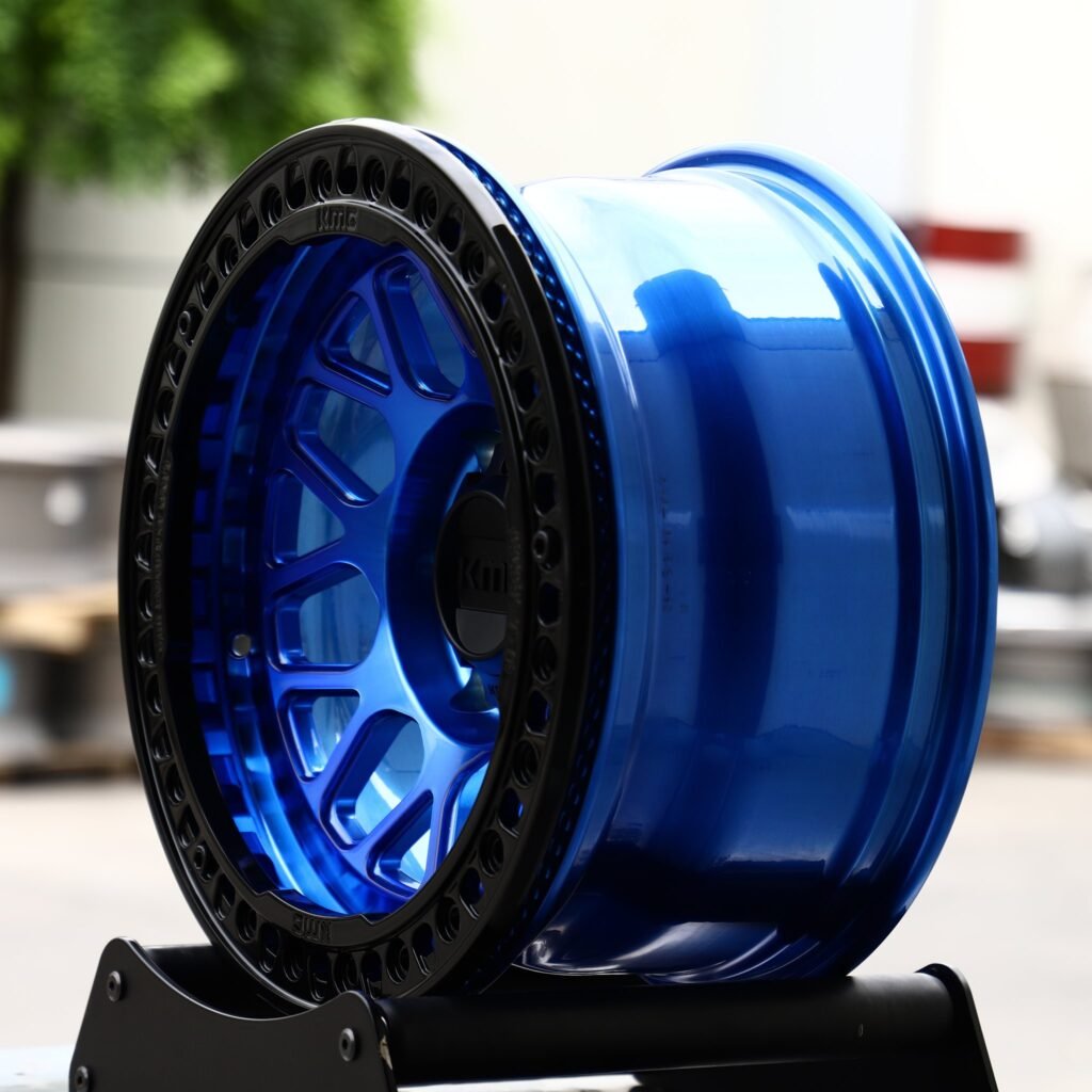 Toyota Tacoma wheels – KMC Transparent / Blue / Gloss Black Beadlock, angled view
