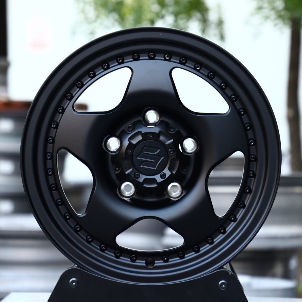 Suzuki Jimny wheels – Matte Black Semi-Full-Face Riveted Wide Lip (Suzuki OEM-Style), front view