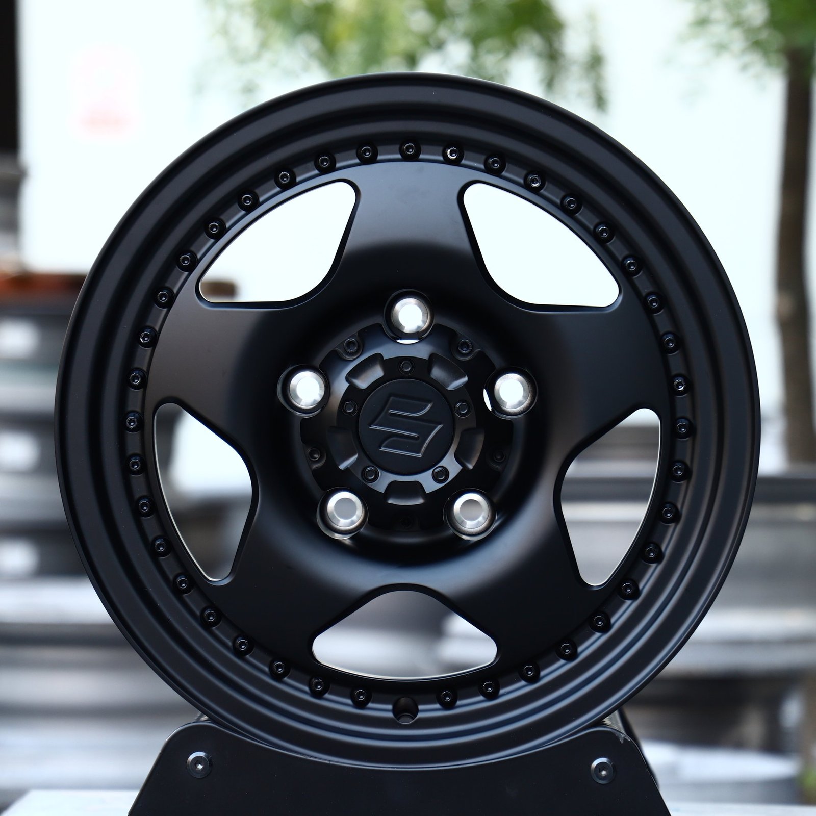 Suzuki Jimny wheels – Matte Black Semi-Full-Face Riveted Wide Lip (Suzuki OEM-Style), front view