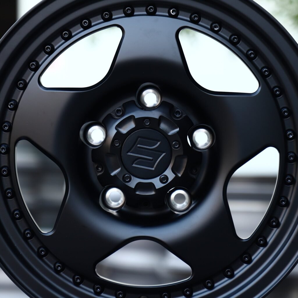Suzuki Jimny wheels – Matte Black Semi-Full-Face Riveted Wide Lip (Suzuki OEM-Style), lip and barrel detail