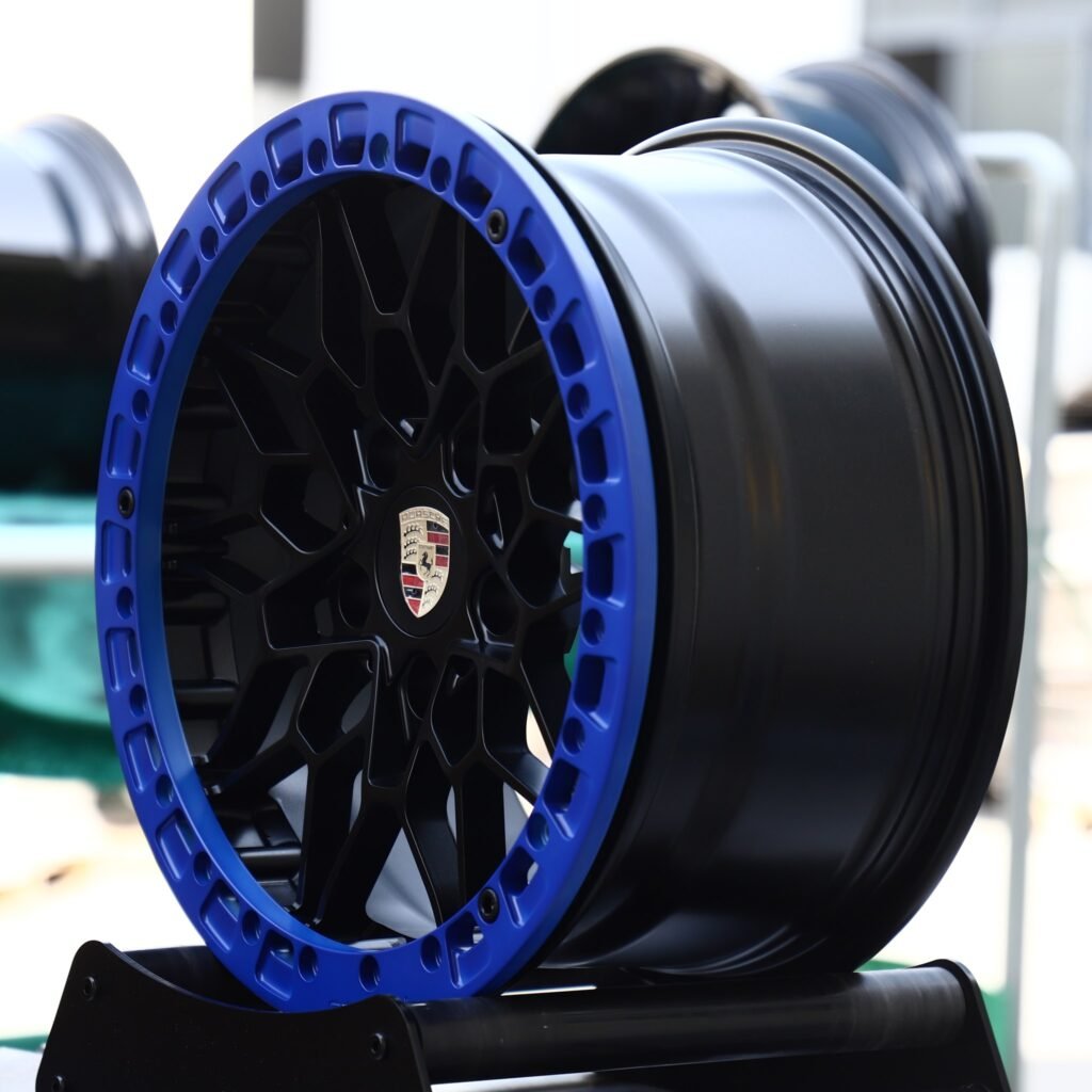 Porsche Panamera wheels – Gloss Black Mesh Blue-Ring Beadlock (Porsche OEM-Style), angled view