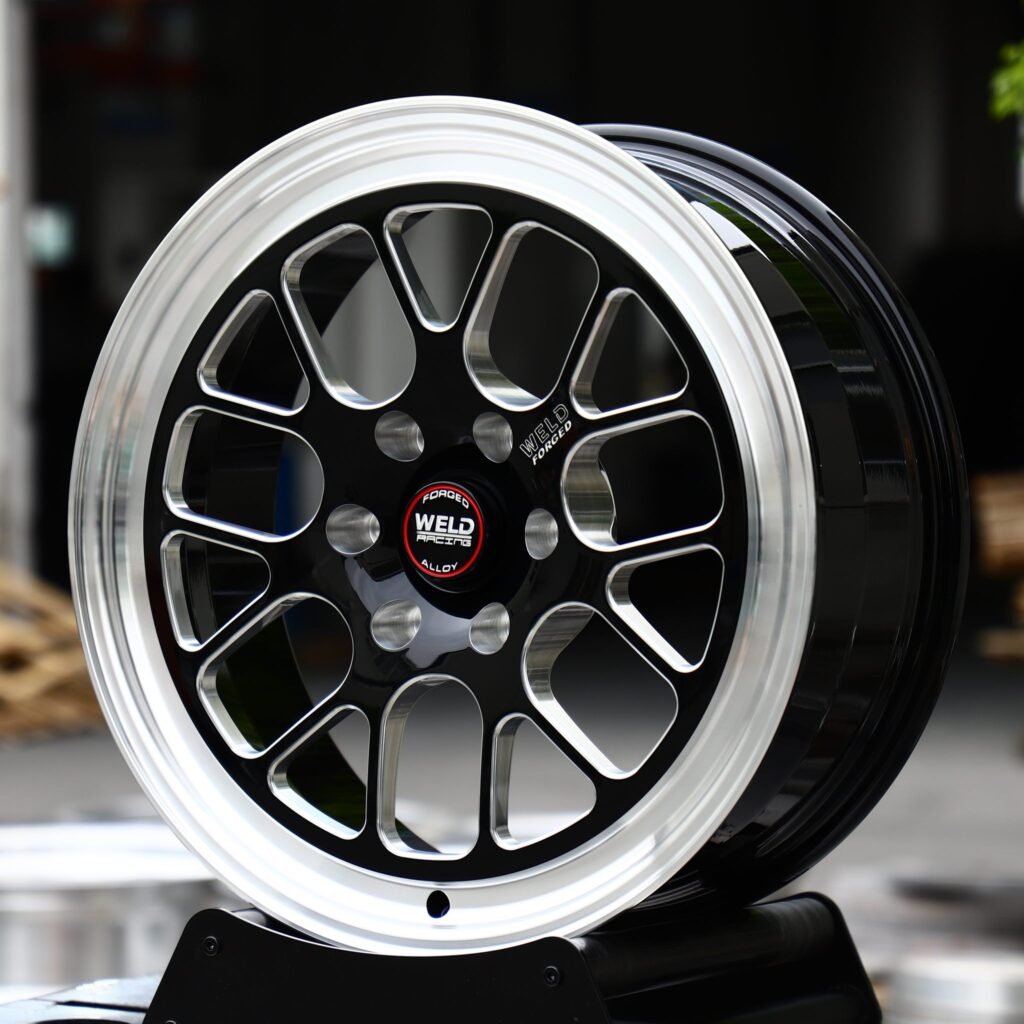 Ford F-150 wheels – Gloss Black Milled 12-Spoke Polished Lip (Weld Racing-Style), angled view
