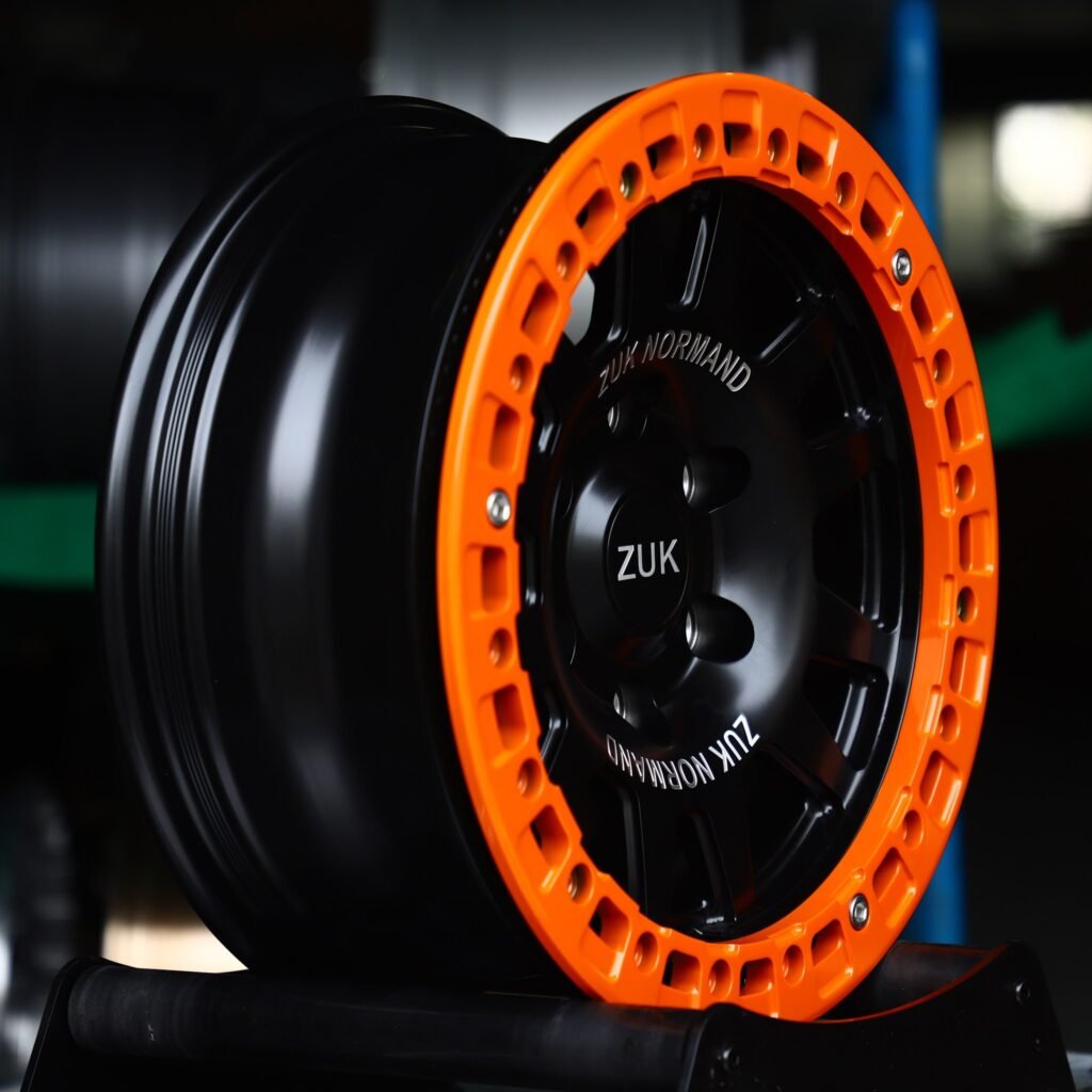 6x139.7 wheels – Matte Black 10-Spoke Orange-Ring Beadlock (ZUK-Style), side view