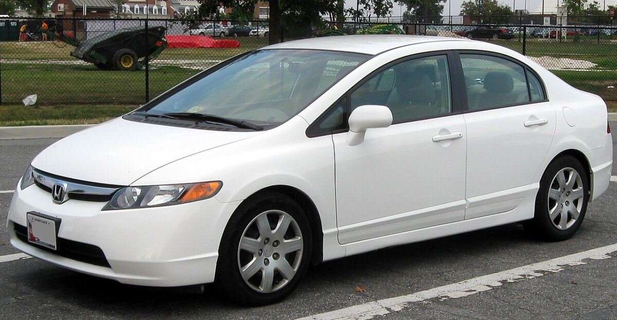 2006-2008 Honda Civic LX sedan (8th generation) in white on factory alloy wheels, front three-quarter view