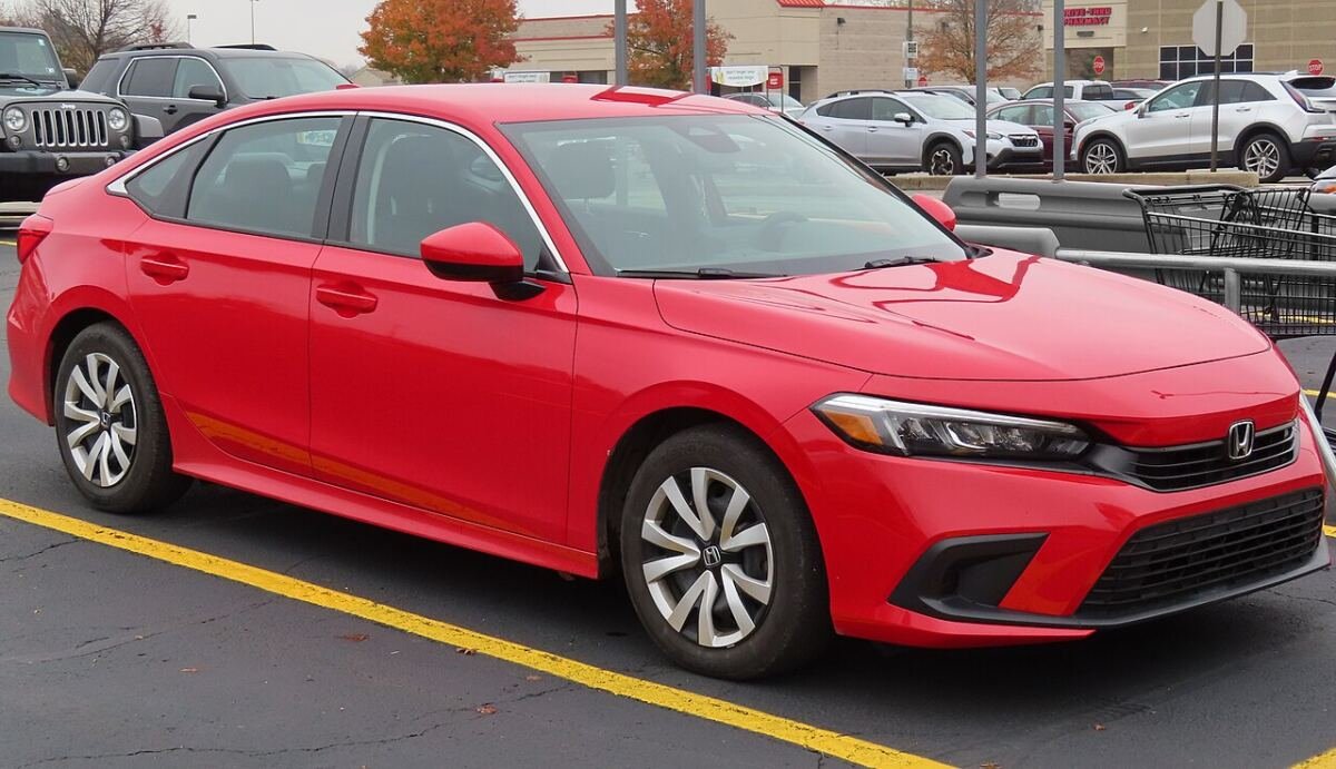 2022 Honda Civic sedan (11th generation) in red, front three-quarter view, a car covered by these Honda Civic wheel specs