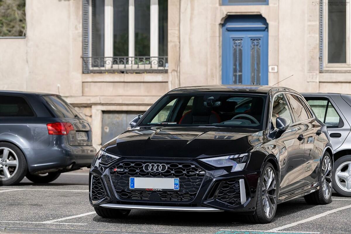 Black Audi RS3 Sportback 8Y parked on a street, showing the factory 19-inch wheels
