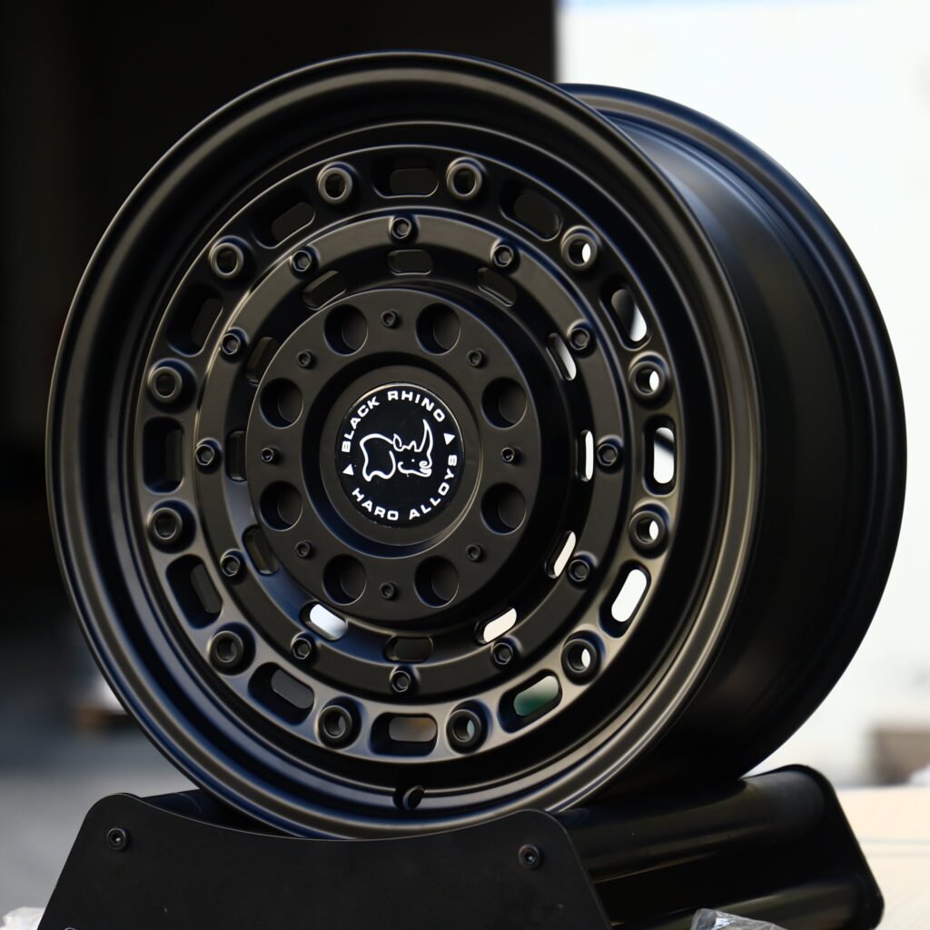 Toyota Tacoma wheels – Matte Black Oval-Slot Bolt Ring (Black Rhino-Style), angled view