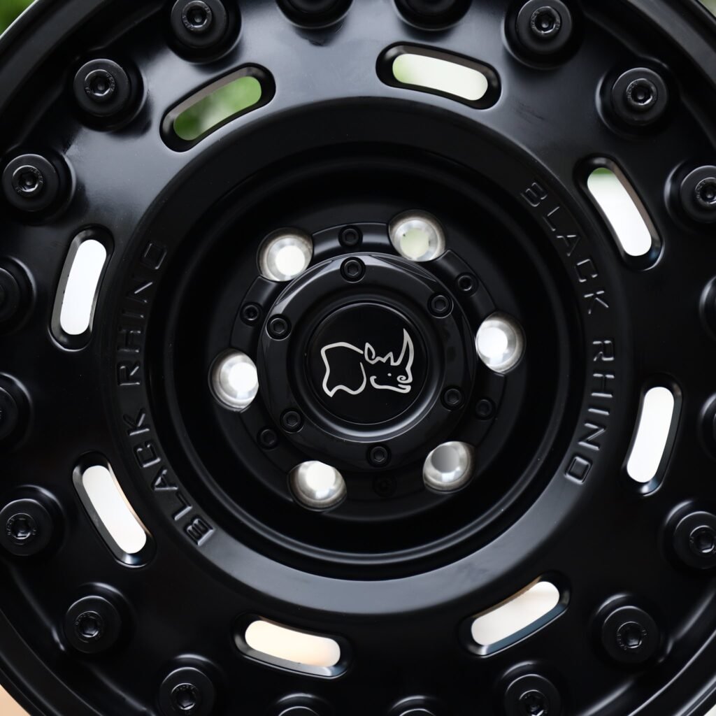 Toyota Tacoma wheels – Matte Black Round-Slot Bolt Ring (Black Rhino-Style), lip and barrel detail