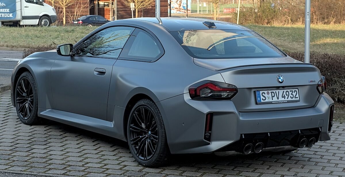 Grey BMW M2 G87 coupe from the rear three-quarter, a 5x112 bolt pattern car