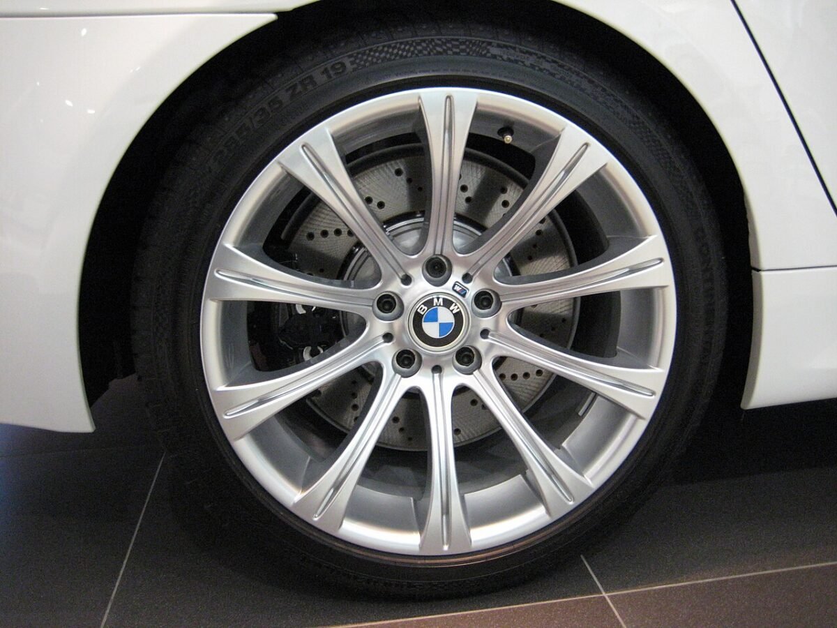 Silver factory BMW E60 M5 wheel showing five lug holes and the center cap