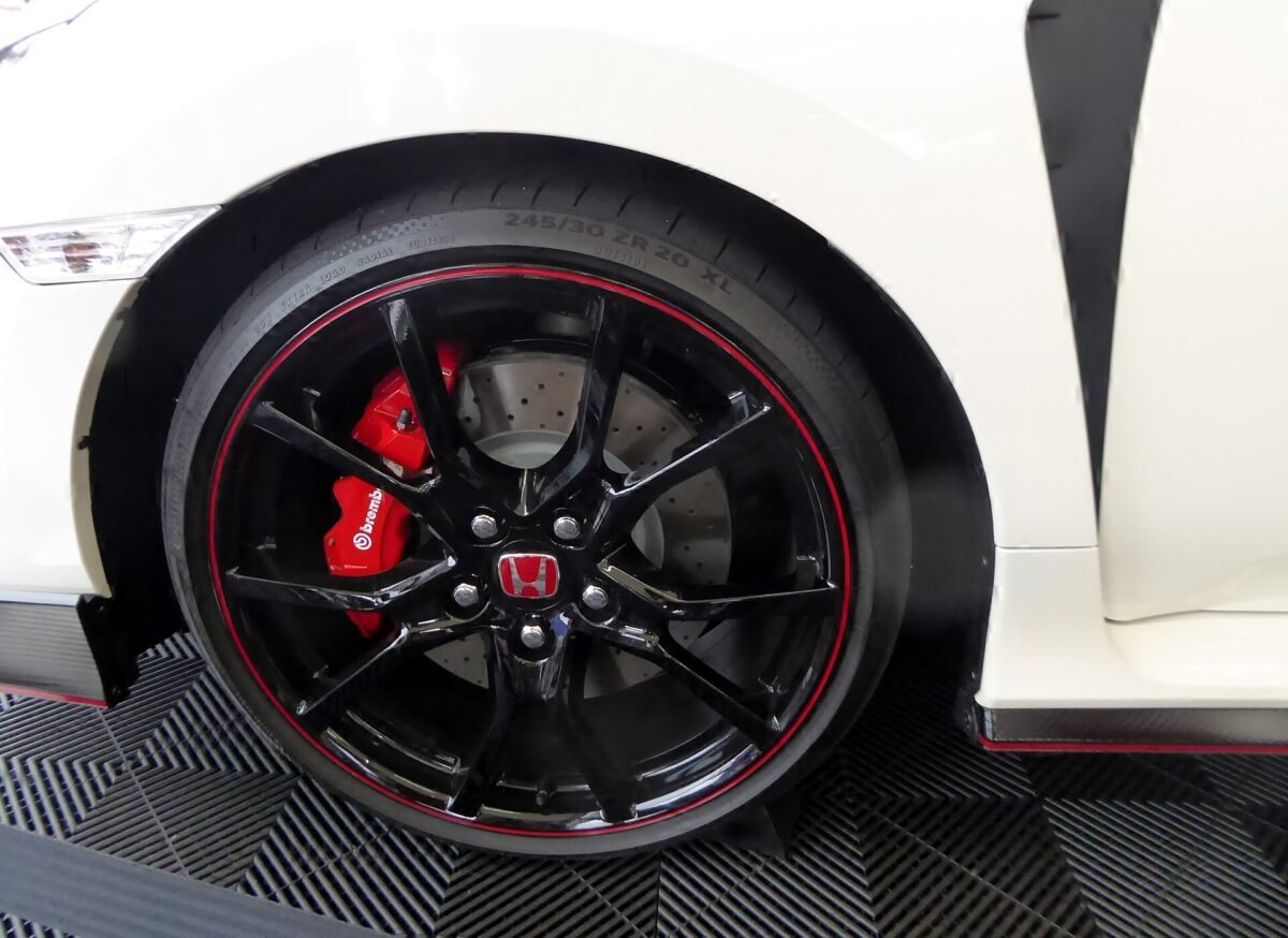 Factory 20-inch black and red Honda Civic Type R FK8 wheel with 245/30 ZR20 tire and red Brembo caliper