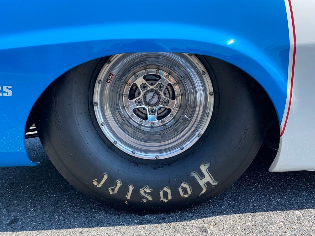 Hoosier bias-ply drag slick mounted on a polished 15-inch drag wheel, side view
