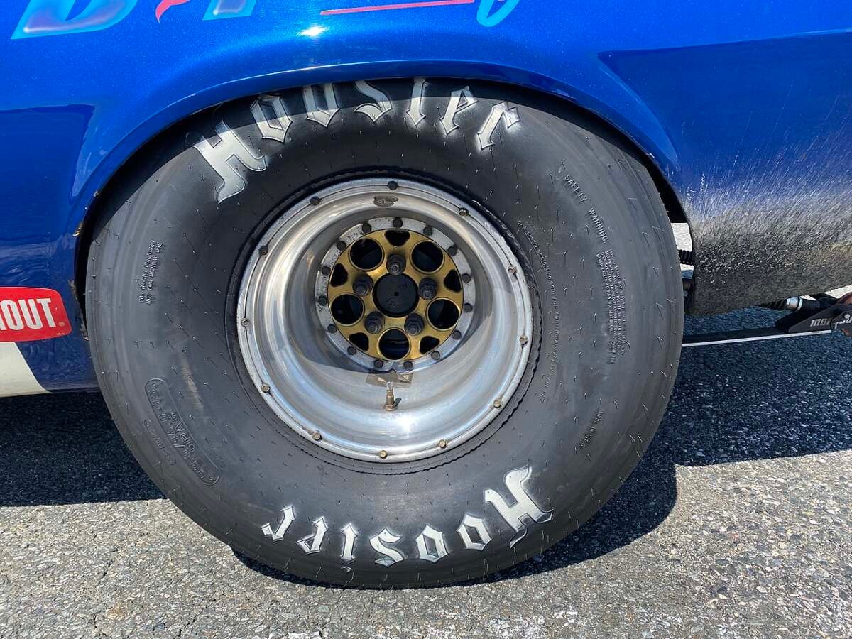 Hoosier drag slick on a 15-inch wheel under the rear fender of an AMC AMX SS drag car