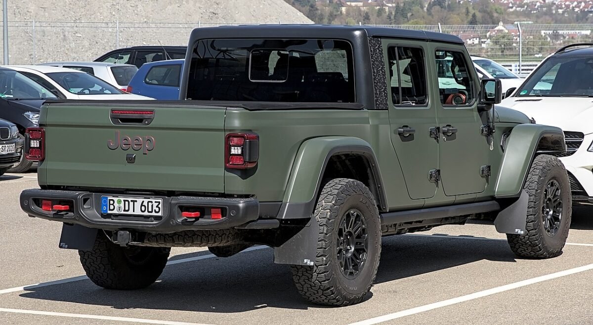 Green Jeep Gladiator JT pickup, rear view, shares the 5x127 bolt pattern with the Wrangler JL