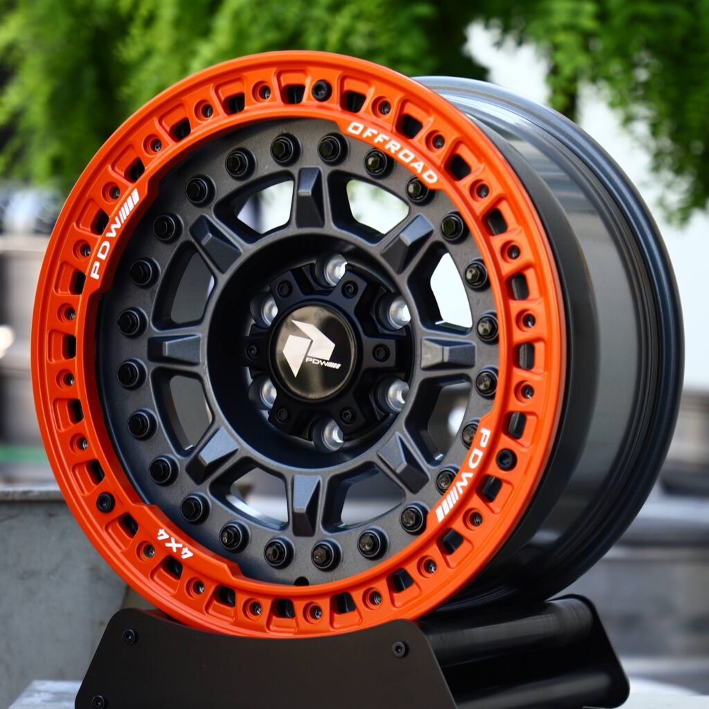 Toyota Tacoma wheels – Matte Black 8-Spoke Orange-Ring Beadlock (PDW Offroad-Style), angled view