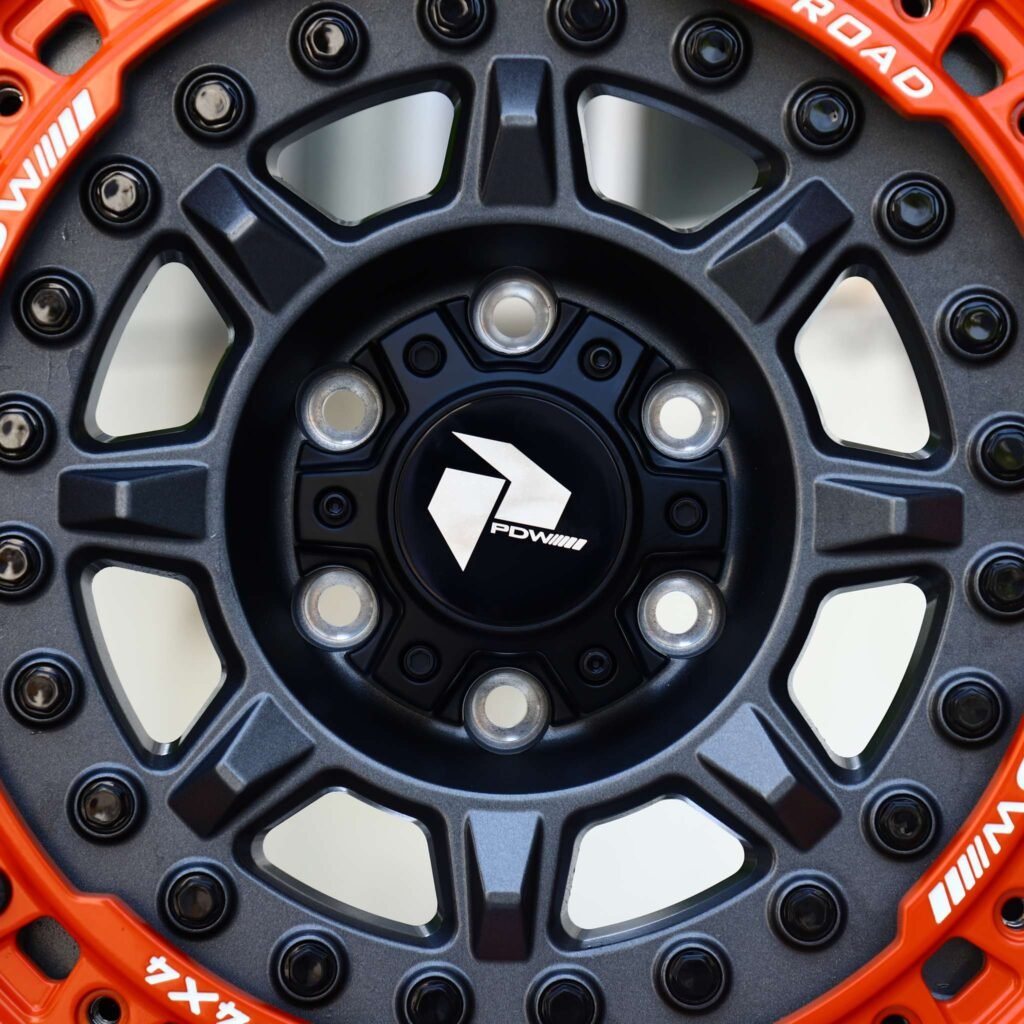 Toyota 4Runner wheels – Matte Black 8-Spoke Orange-Ring Beadlock (PDW Offroad-Style), lip and barrel detail
