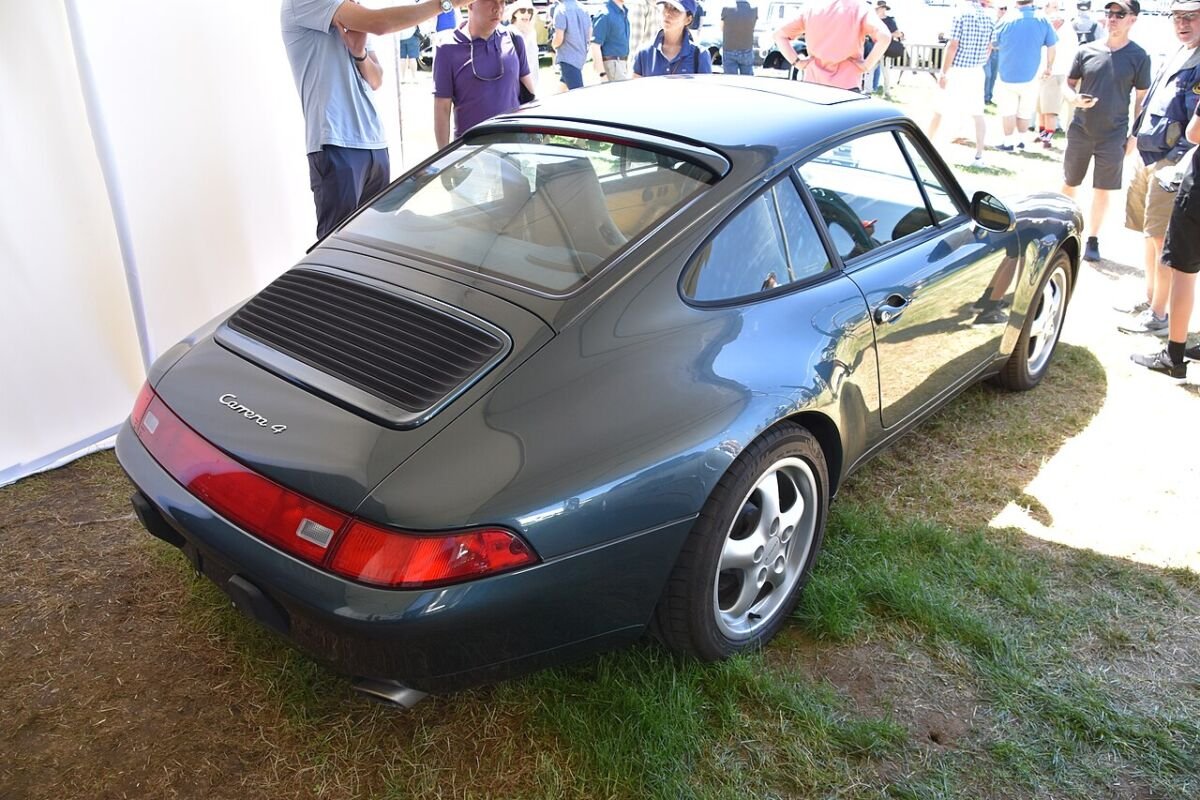 Rear three-quarter view of a Porsche 911 993 Carrera 4 showing its five-spoke wheel