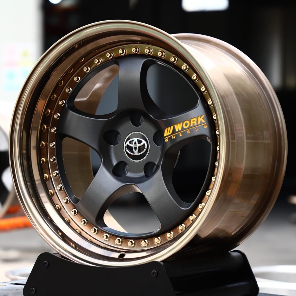 Toyota GR86 wheels – 2-Piece Satin Black 5-Spoke Gold Rivets Bronze Lip (Toyota OEM-Style), angled view
