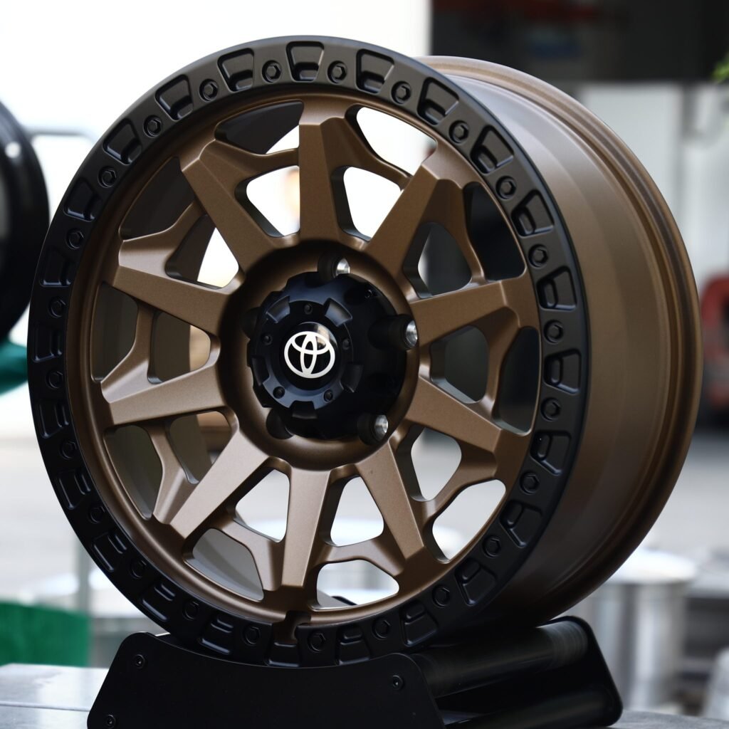 Toyota Land Cruiser wheels – Matte Bronze 10-Spoke Black-Ring Beadlock (Toyota OEM-Style), angled view