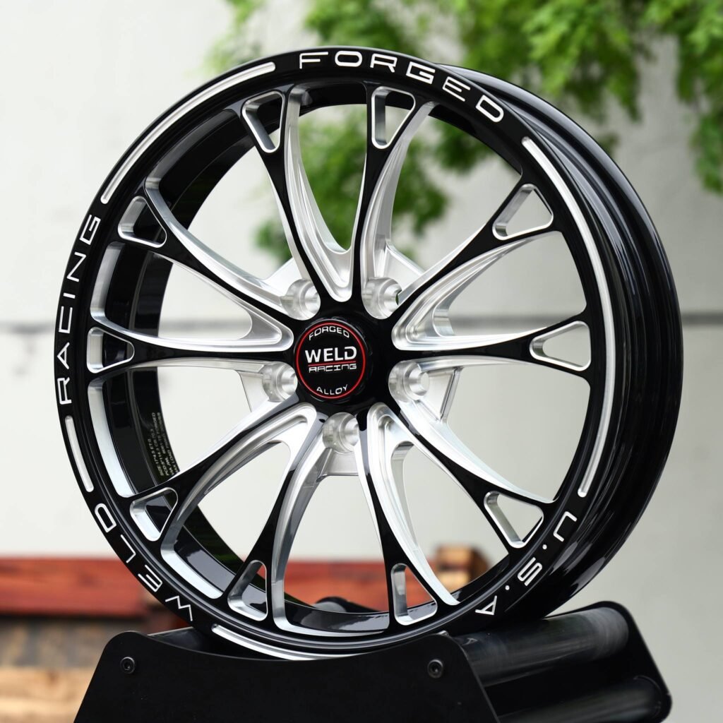 Cadillac CT5 wheels – Black Machined 10-Spoke Lettered Lip (Weld Racing-Style), close-up view