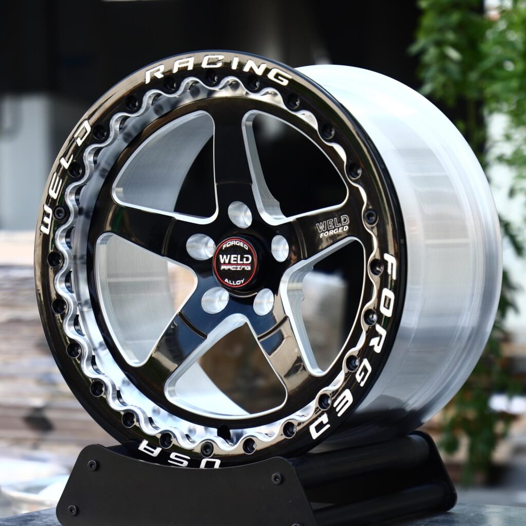 Dodge Challenger wheels – Black Machined Beadlock Wavy-Ring 5-Spoke (Weld Racing-Style), angled view
