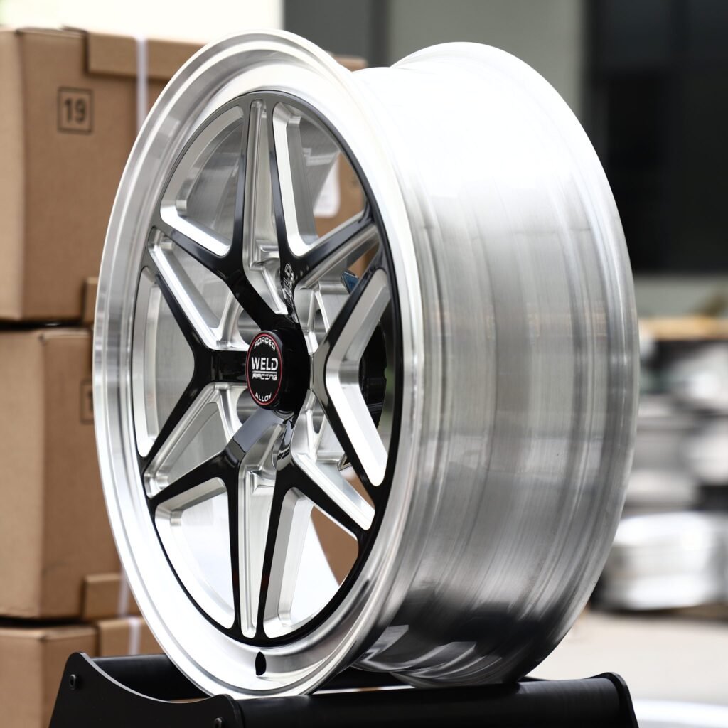 Toyota Tacoma wheels – Gloss Black Milled Split-Spoke Star Polished Lip (Weld Racing-Style), angled view