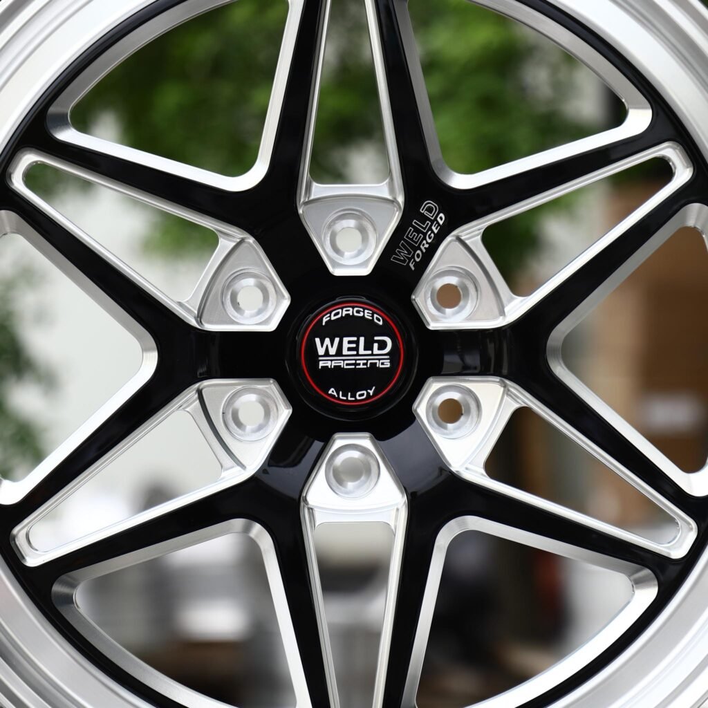 6x139.7 wheels – Gloss Black Milled Split-Spoke Star Polished Lip (Weld Racing-Style), side view