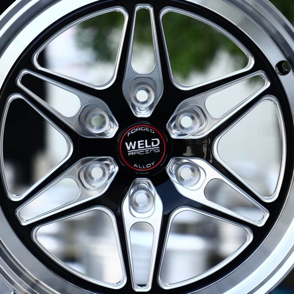 6x139.7 wheels – Gloss Black Milled Twin-Spoke Star Polished Lip (Weld Racing-Style), side view